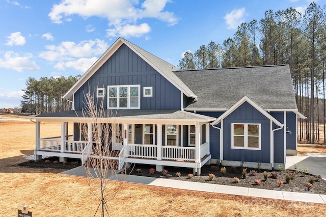 view of front of property featuring board and batten siding, covered porch, and a shingled roof