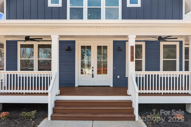 view of exterior entry with covered porch, a ceiling fan, and board and batten siding