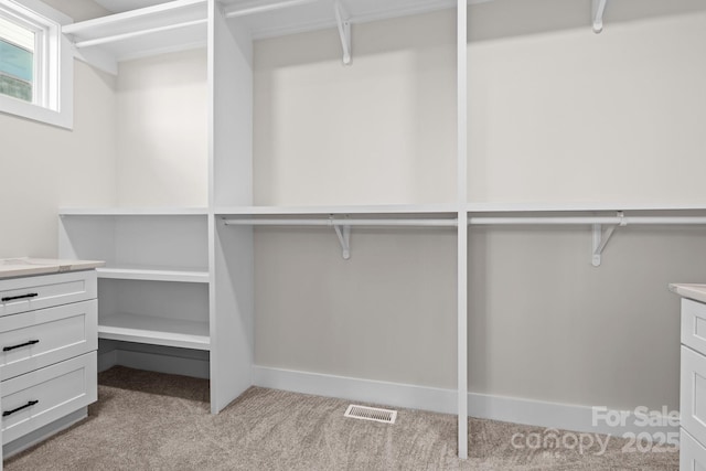 walk in closet with light carpet and visible vents