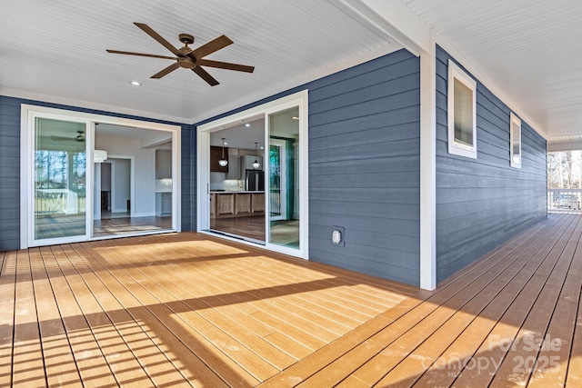 wooden terrace featuring a ceiling fan