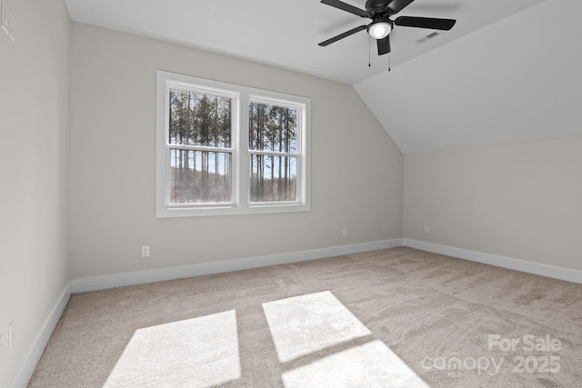 additional living space featuring vaulted ceiling, light carpet, visible vents, and baseboards