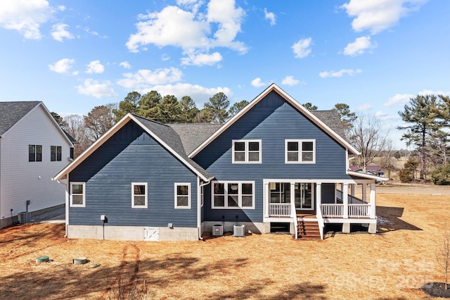 rear view of property featuring covered porch