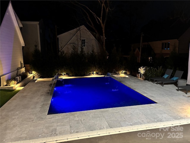 outdoor pool with a patio area