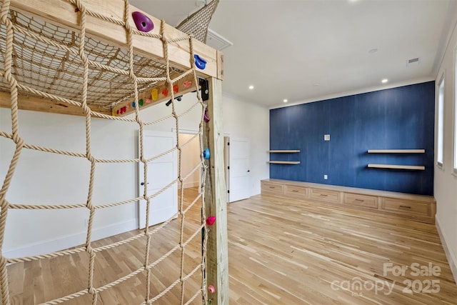 interior space with baseboards, visible vents, wood finished floors, and recessed lighting