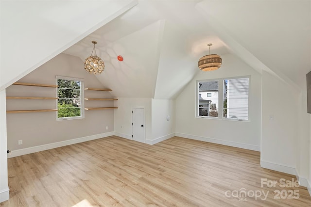 bonus room with a healthy amount of sunlight, baseboards, and wood finished floors