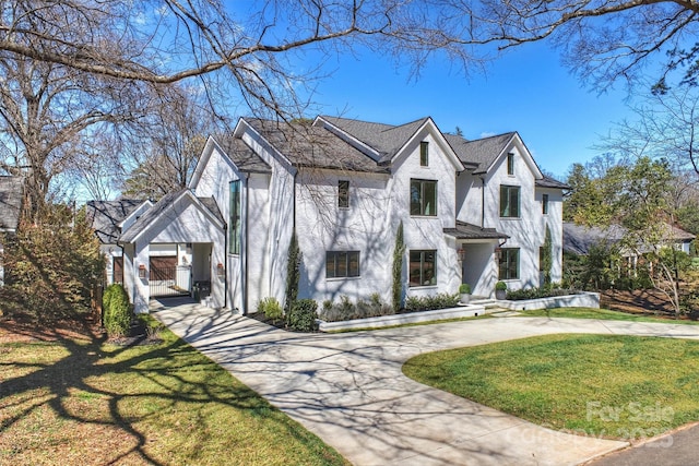 view of front of house featuring a front lawn and concrete driveway