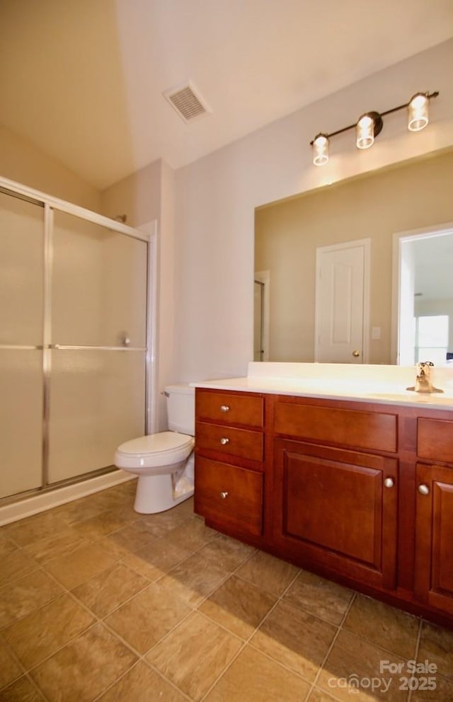 bathroom featuring toilet, a shower stall, visible vents, and vanity