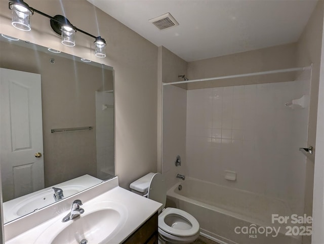 full bathroom featuring toilet, bathing tub / shower combination, vanity, and visible vents