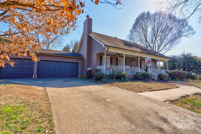 view of front of property featuring a porch, driveway, and a chimney