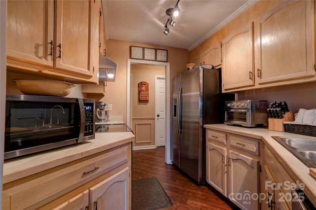 kitchen featuring stainless steel appliances, a toaster, light countertops, and light brown cabinets