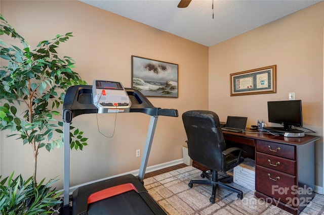 office with a ceiling fan, light wood-type flooring, and baseboards