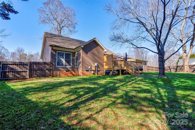 view of home's exterior featuring crawl space, fence, and a lawn