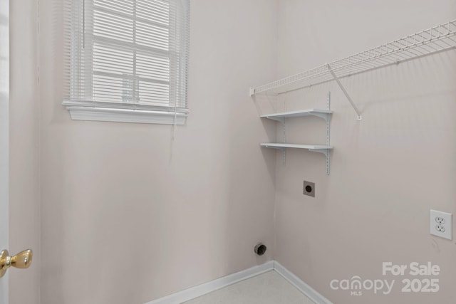 laundry area featuring laundry area, baseboards, and hookup for an electric dryer