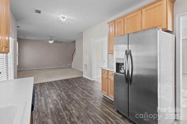 kitchen with stainless steel refrigerator with ice dispenser, visible vents, a ceiling fan, dark wood-type flooring, and light brown cabinets