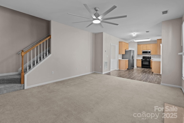 interior space with visible vents, stairs, dark carpet, and baseboards