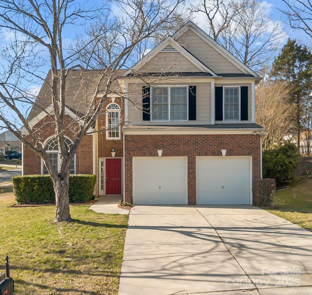 traditional-style home with a garage, a front yard, brick siding, and driveway