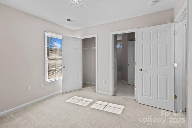 unfurnished bedroom with a closet, carpet, visible vents, and baseboards