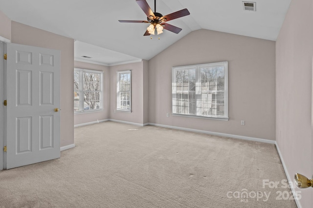 carpeted spare room with vaulted ceiling, ceiling fan, visible vents, and baseboards