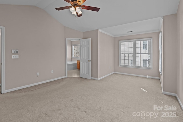 unfurnished bedroom featuring carpet floors, vaulted ceiling, and baseboards