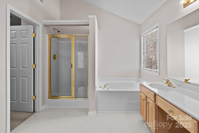 bathroom with a stall shower, vaulted ceiling, vanity, and a bath