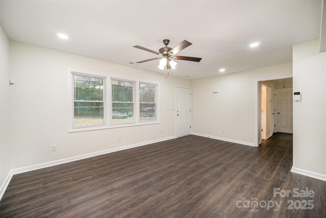 spare room with a ceiling fan, recessed lighting, dark wood-style flooring, and baseboards