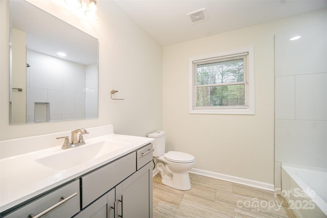 full bathroom featuring toilet, vanity, visible vents, baseboards, and a shower