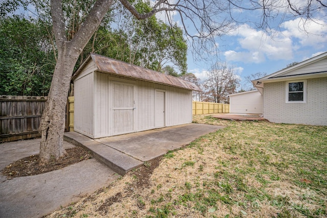 view of shed featuring fence