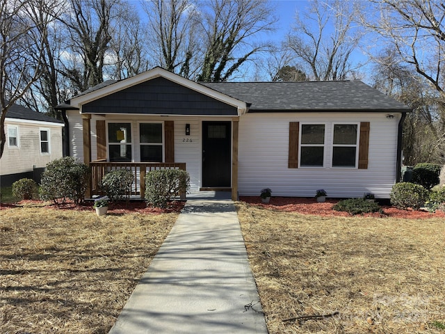 view of front of home with a porch and roof with shingles