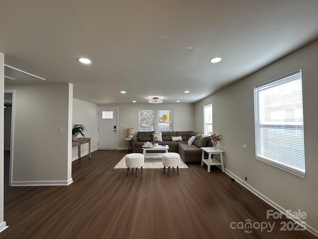 living area featuring dark wood-style floors, baseboards, and recessed lighting