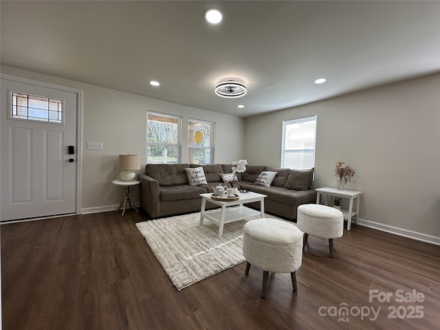 living area featuring baseboards, dark wood-style flooring, and recessed lighting