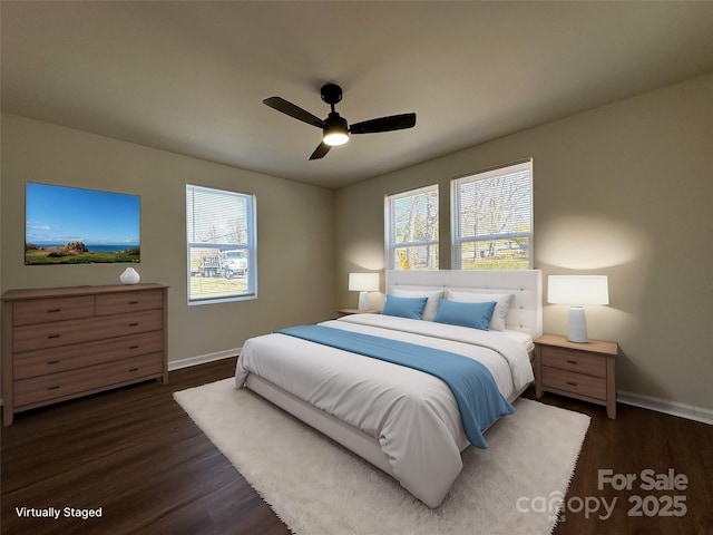 bedroom featuring a ceiling fan, dark wood-style flooring, and baseboards