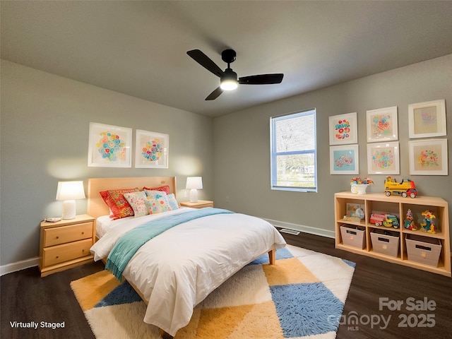 bedroom featuring a ceiling fan, baseboards, and wood finished floors