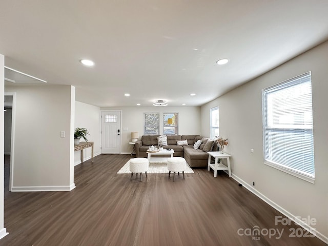 living area featuring baseboards, dark wood-style flooring, and recessed lighting