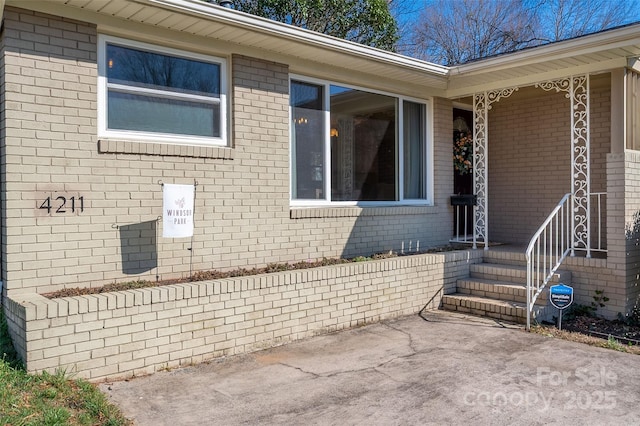 exterior space with brick siding