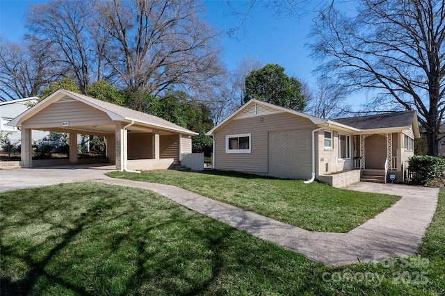 exterior space with a yard, a carport, brick siding, and concrete driveway