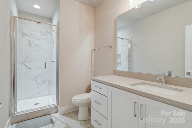 bathroom with toilet, vanity, baseboards, marble finish floor, and a stall shower