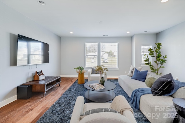 living room with baseboards, wood finished floors, and recessed lighting