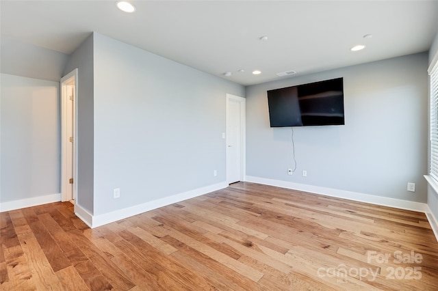 interior space featuring visible vents, baseboards, wood finished floors, and recessed lighting