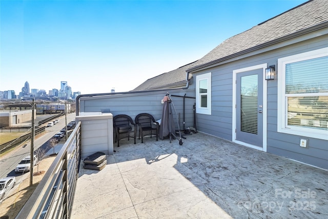 view of patio / terrace with a balcony and a city view