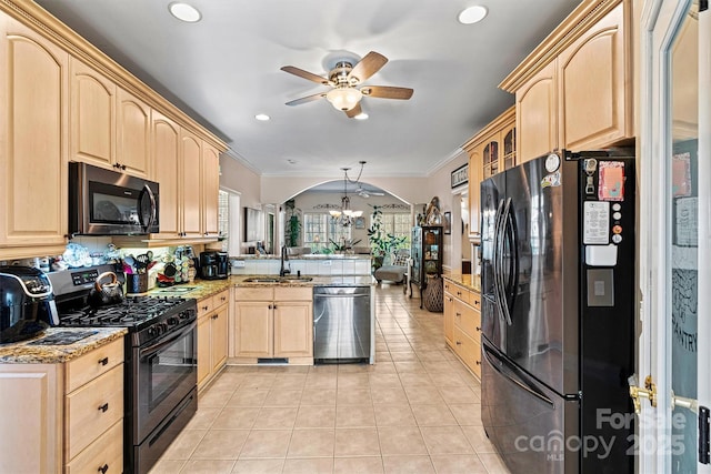 kitchen featuring a sink, black appliances, a peninsula, and light brown cabinets