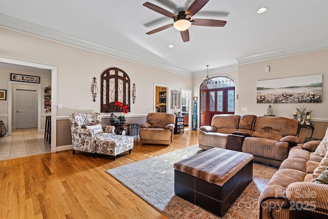 living area featuring crown molding, light wood finished floors, recessed lighting, ceiling fan, and baseboards