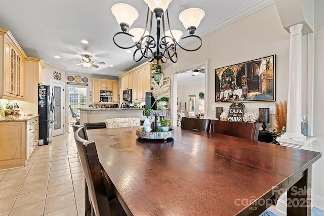 dining space featuring decorative columns, recessed lighting, ornamental molding, light tile patterned flooring, and ceiling fan with notable chandelier