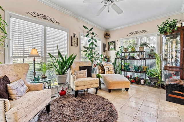 living area featuring light tile patterned floors, ceiling fan, and crown molding