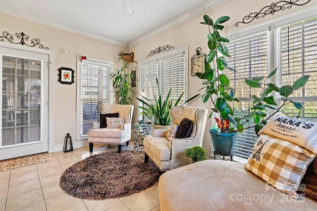 living area with baseboards, ornamental molding, and tile patterned floors