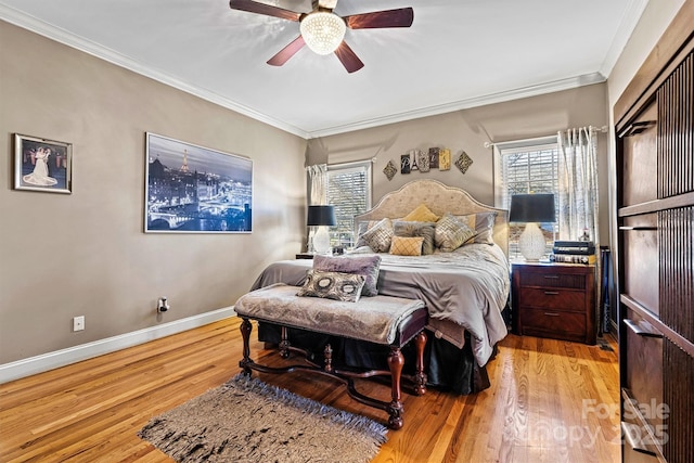 bedroom featuring multiple windows, wood finished floors, and crown molding