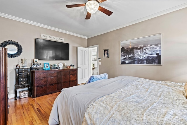 bedroom with light wood finished floors, a ceiling fan, and crown molding