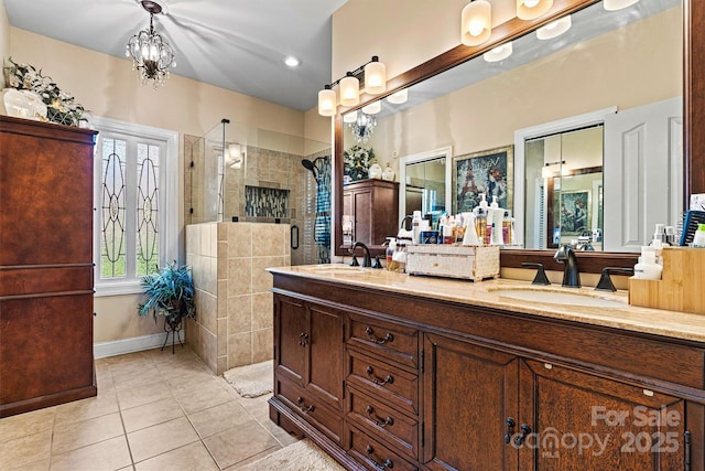 full bath with tile patterned flooring, a sink, a tile shower, and double vanity