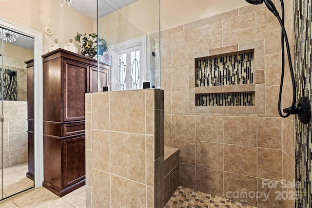 full bathroom with tile patterned flooring and tiled shower