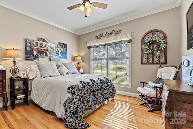 bedroom with a ceiling fan, crown molding, light wood-style flooring, and baseboards