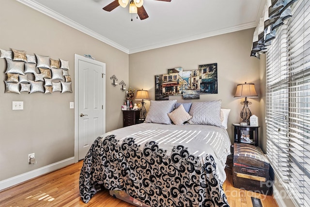 bedroom featuring visible vents, baseboards, crown molding, and wood finished floors